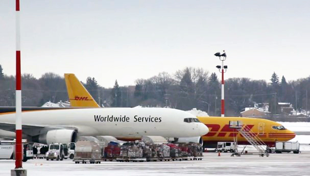 Two cargo aircraft parked on the apron on a winter day at the airport