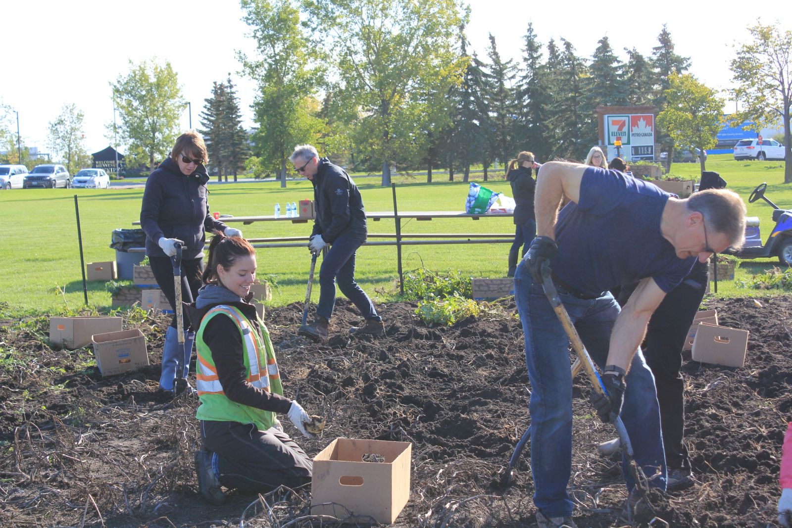 Employees working in the airport garden in support of Winnipeg Harvest